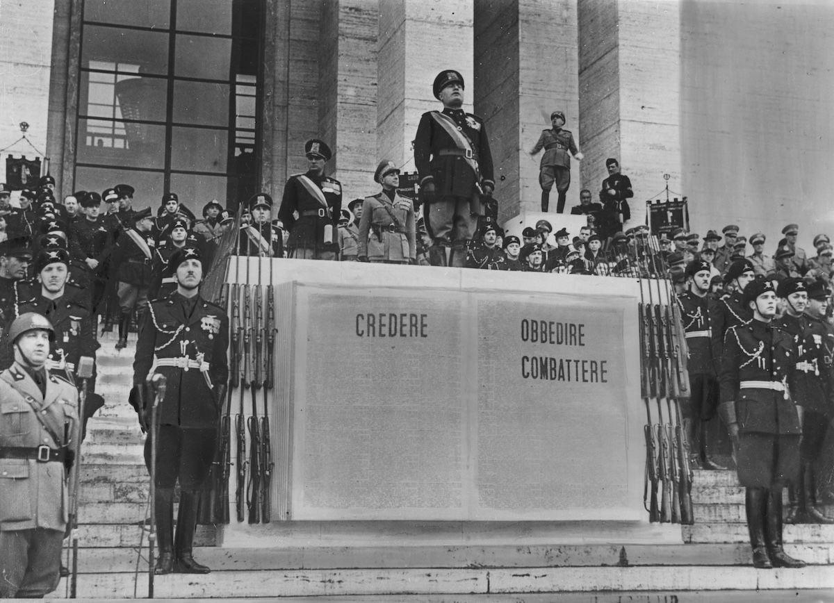 Benito Mussolini at a ceremony for the Italian Academy of Physical Education in Rome, 1940. Narodowe Archiwum Cyfrowe. Public Domain. Benito Mussolini at a ceremony for the Italian Academy of Physical Education in Rome, 1940. Narodowe Archiwum Cyfrowe. Public Domain.